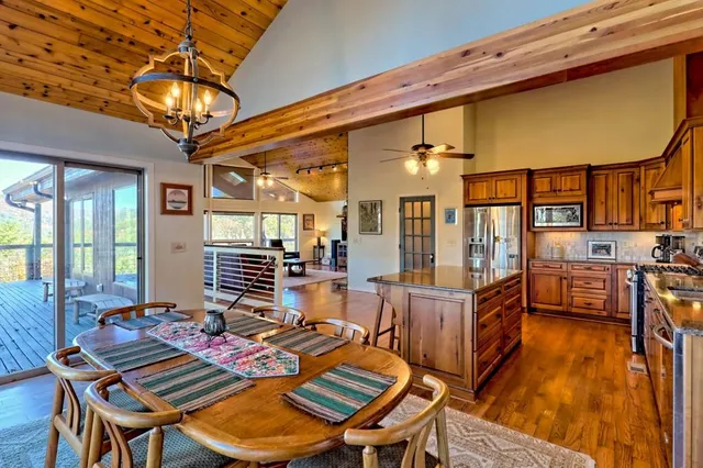 a balcony with wooden floor table and chairs