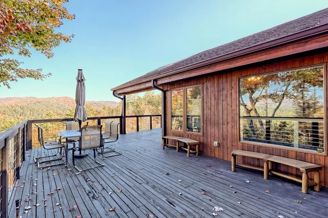 a view of a patio with table and chairs and wooden floor