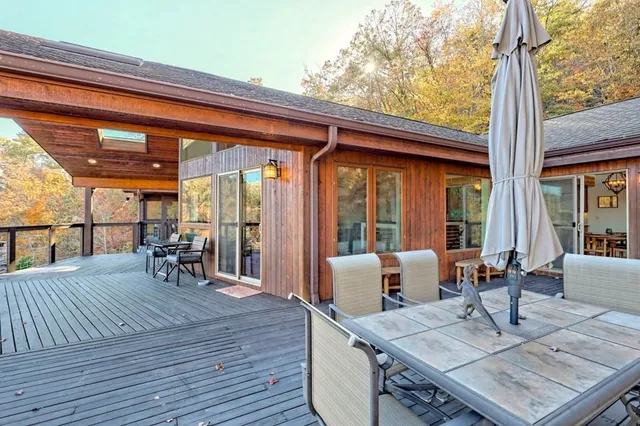 a dinning table and chairs in the patio of a house