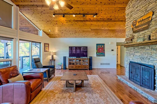 a view of a hallway with wooden floor and furniture