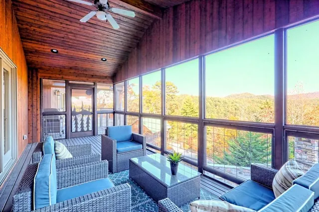 a living room with furniture and a floor to ceiling window