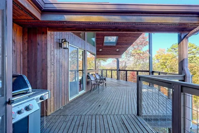 a backyard of a house with wooden floor and sofas