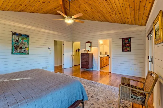 a bedroom with a bed and a lamp