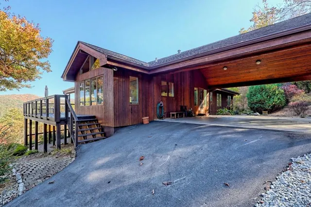 a wooden bench sitting in front of a building
