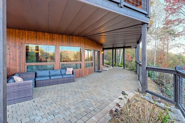 a kitchen with stainless steel appliances granite countertop a stove a refrigerator a dining table and chairs with wooden floor