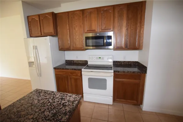 a kitchen with a refrigerator sink and microwave