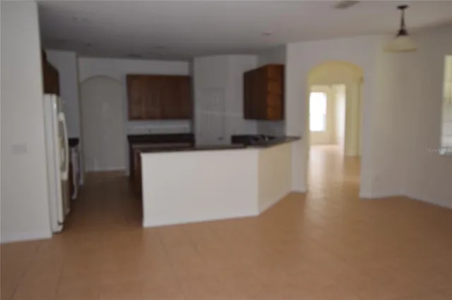 a view of a living room with a flat screen tv and wooden floor