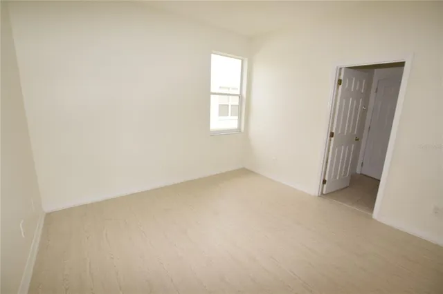 an empty room with windows and closet