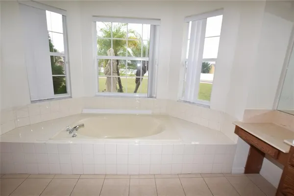 a white bath tub sitting next to a window