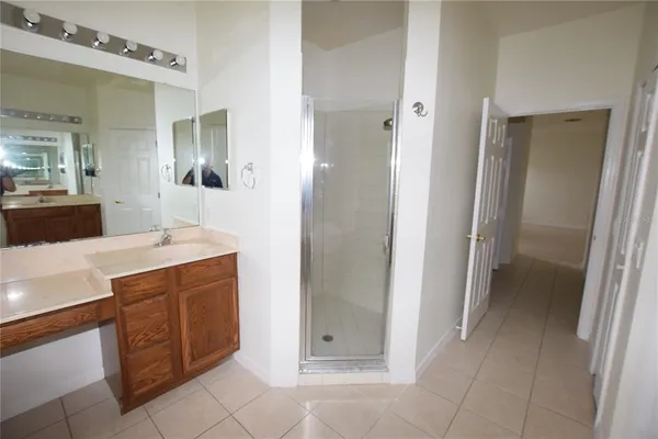 a bathroom with a double vanity sink and mirror