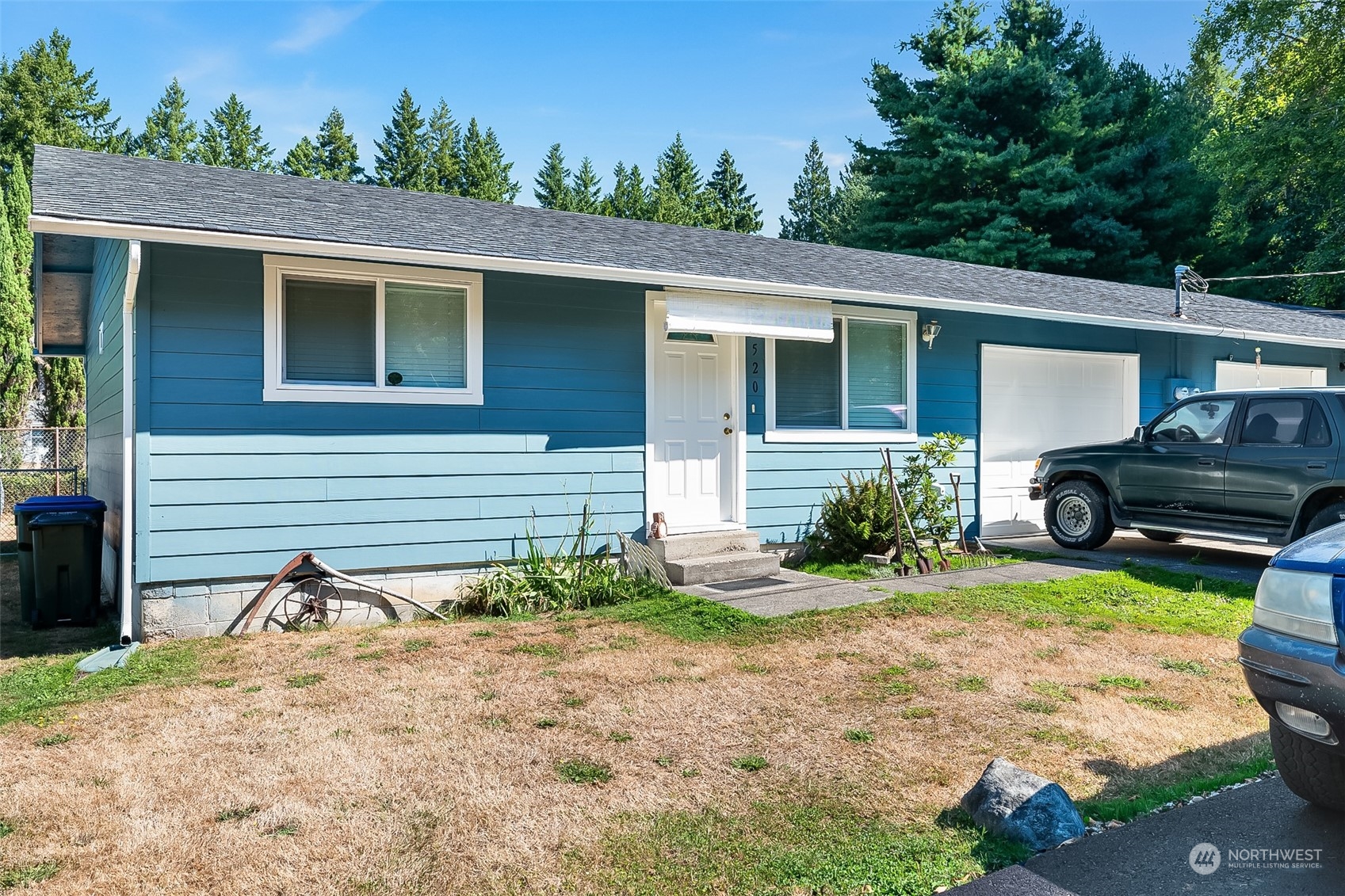 4520 Cooper Point Road Northwest Olympia, WA 98502 - Photo 3 of 10 a front view of a house with garden