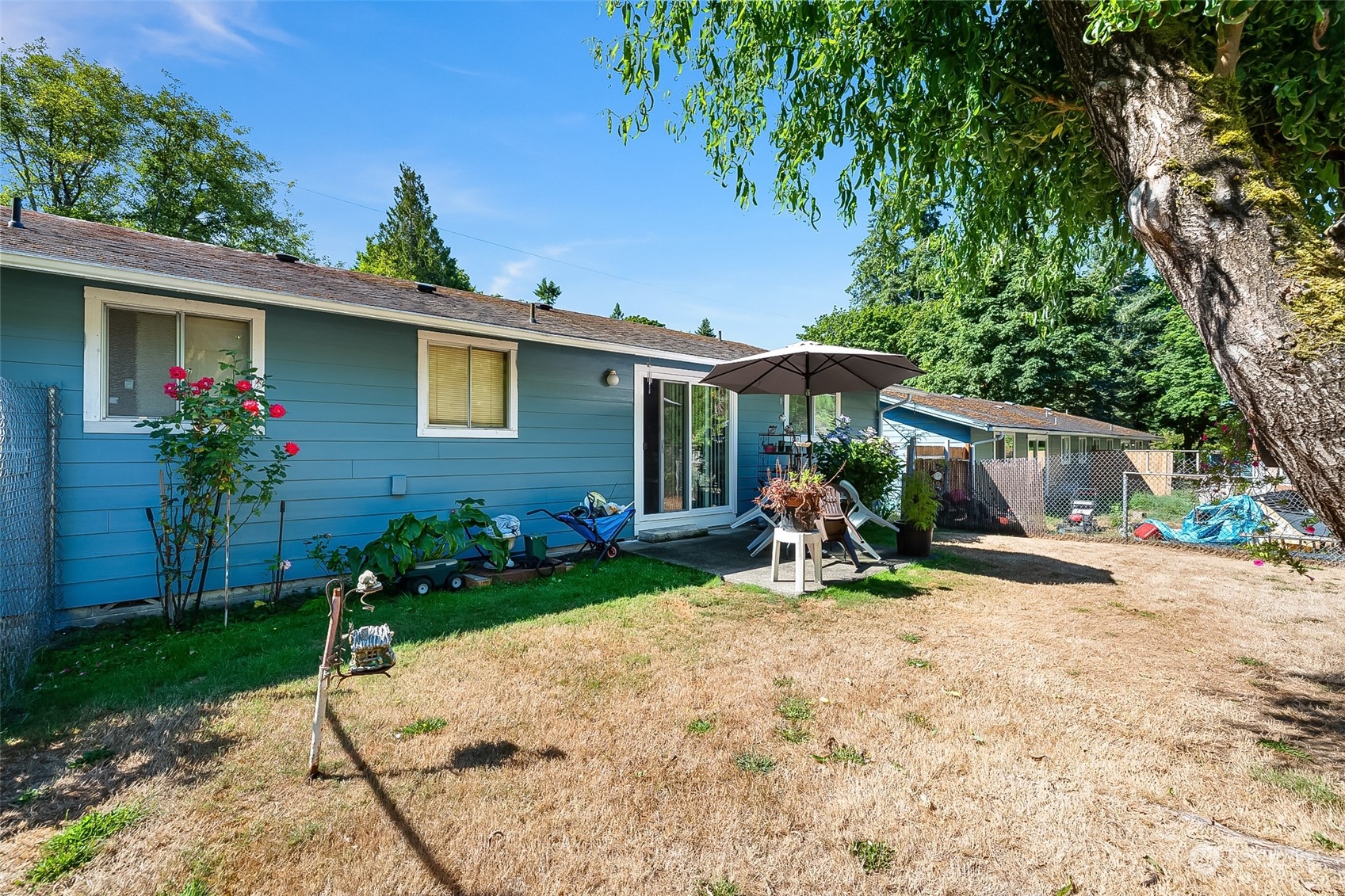 4520 Cooper Point Road Northwest Olympia, WA 98502 - Photo 6 of 10 a view of a house with backyard sitting area and garden