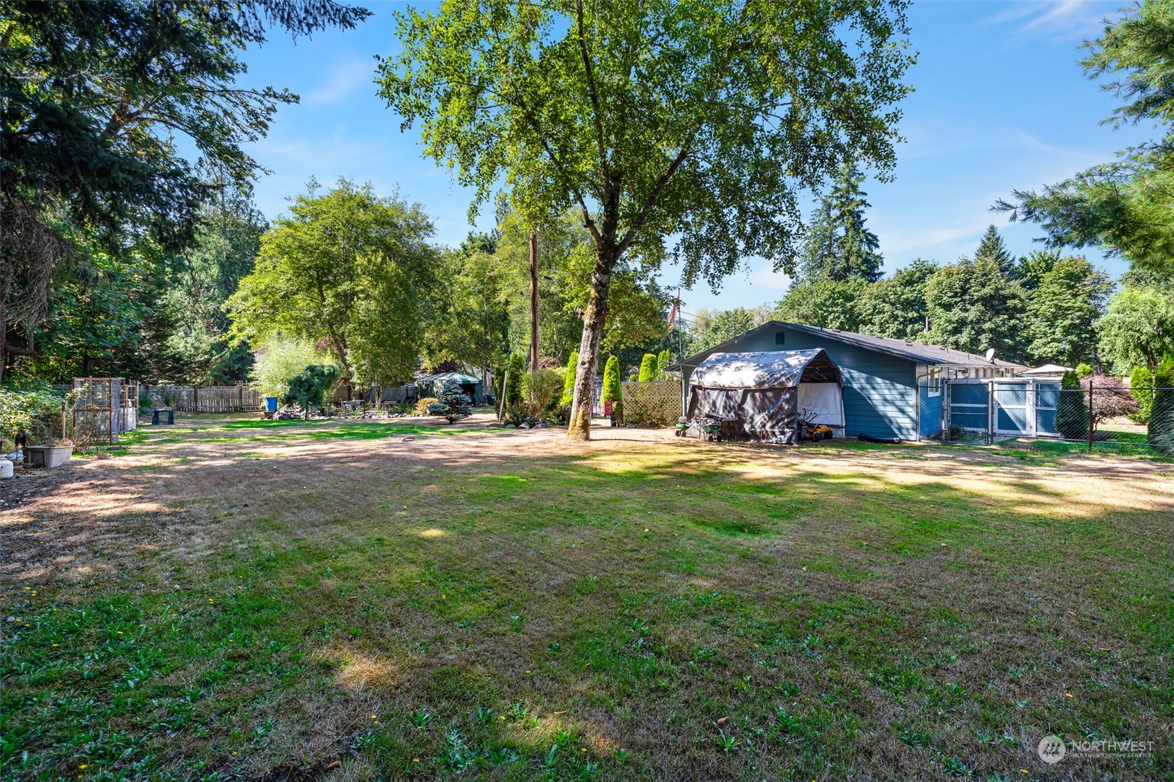 4520 Cooper Point Road Northwest Olympia, WA 98502 - Photo 7 of 10 a backyard of a house with table and chairs