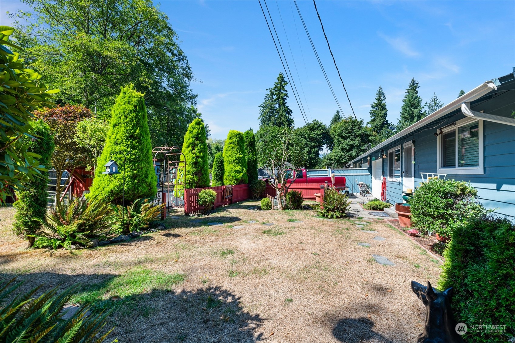 4520 Cooper Point Road Northwest Olympia, WA 98502 - Photo 8 of 10 a view of a house with a small yard and sitting area