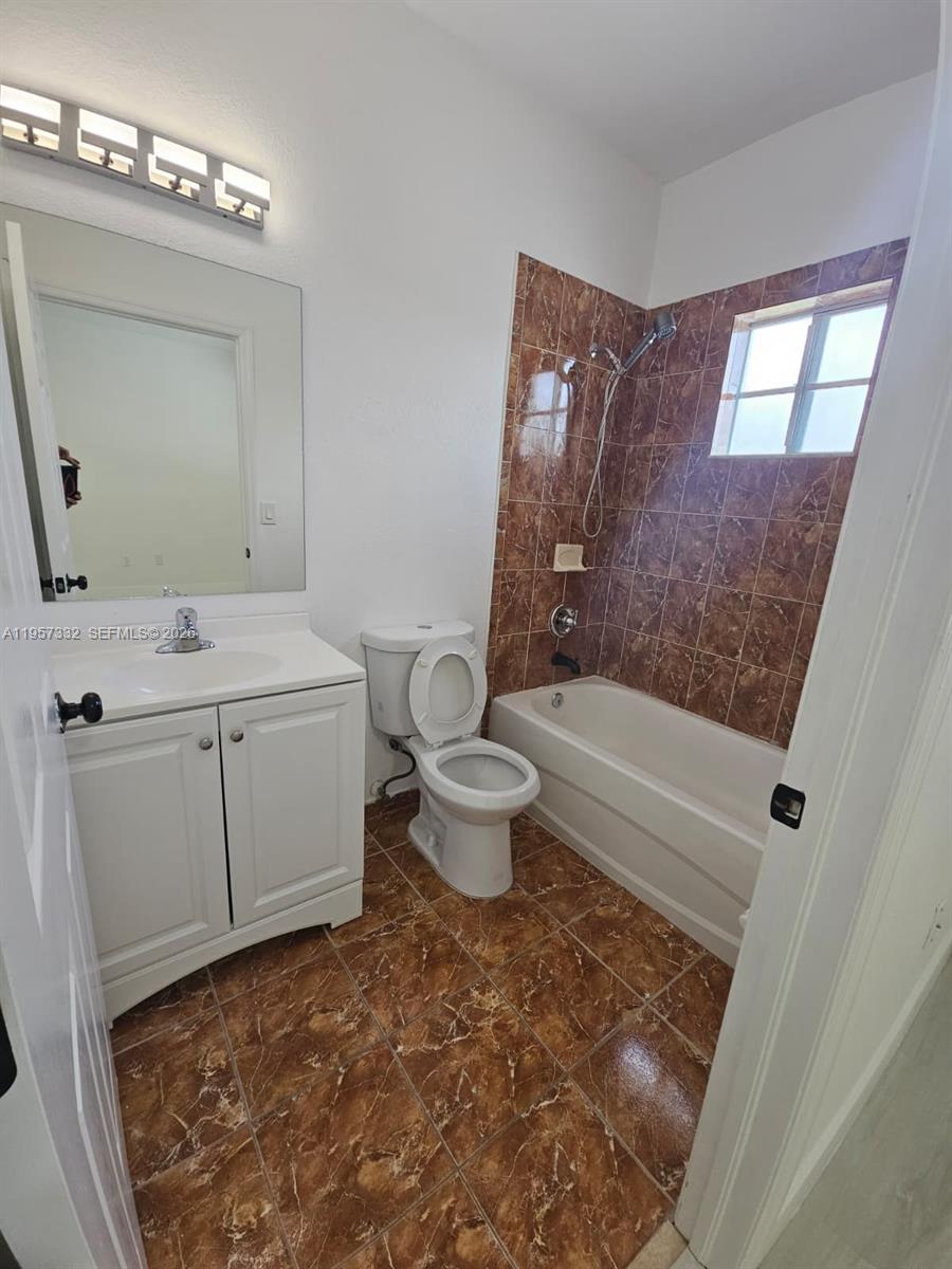 10919 Southwest 182nd Lane Miami, FL 33157 - Photo 25 of 29 a bathroom with a sink toilet and mirror