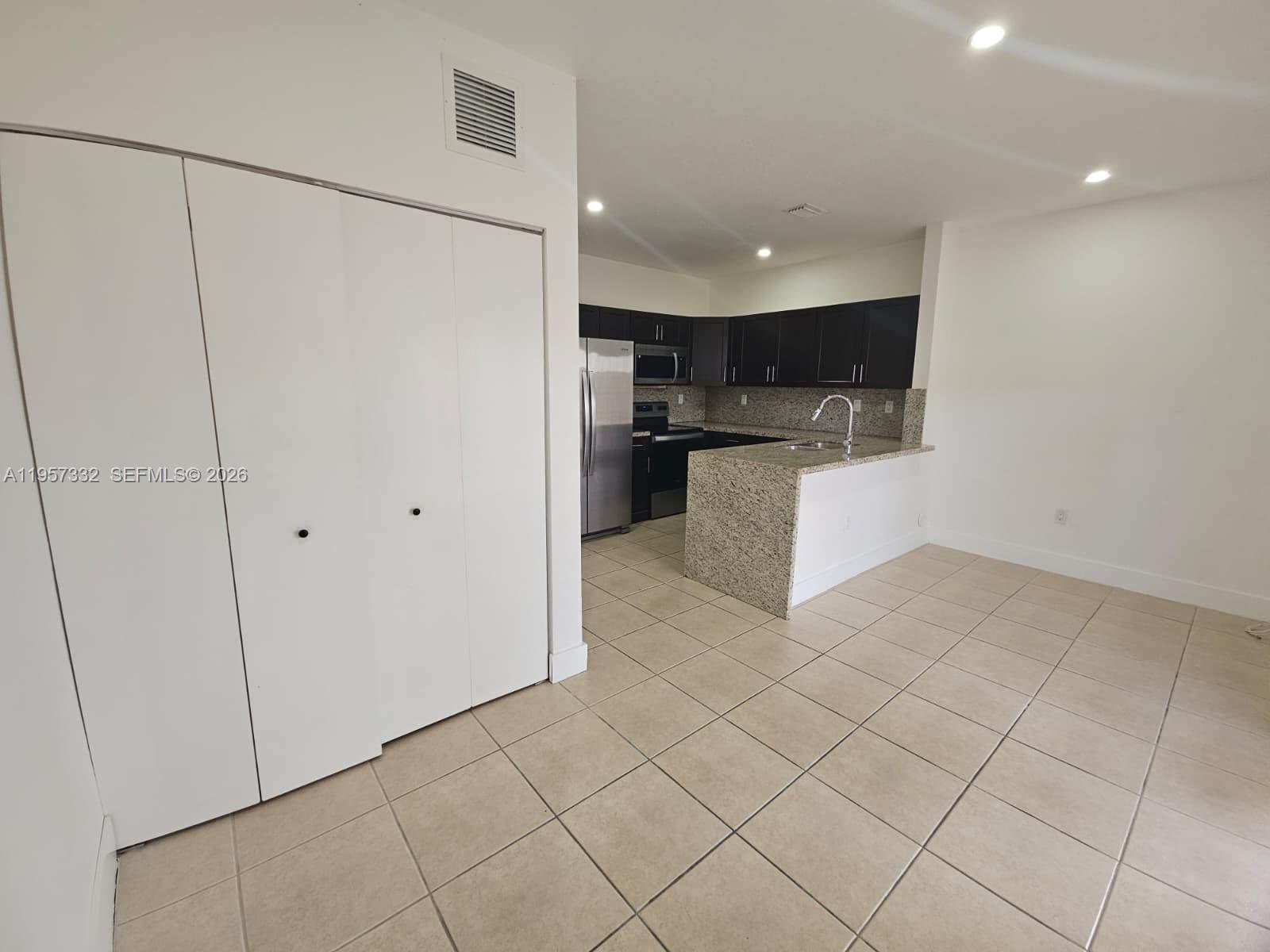 10919 Southwest 182nd Lane Miami, FL 33157 - Photo 7 of 29 a view of kitchen with microwave and cabinets