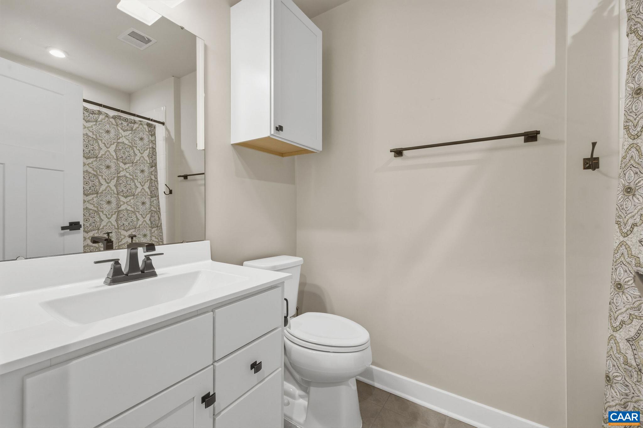 360 Winding Road Keswick, VA 22947 - Photo 38 of 48 a bathroom with a sink a toilet and a mirror