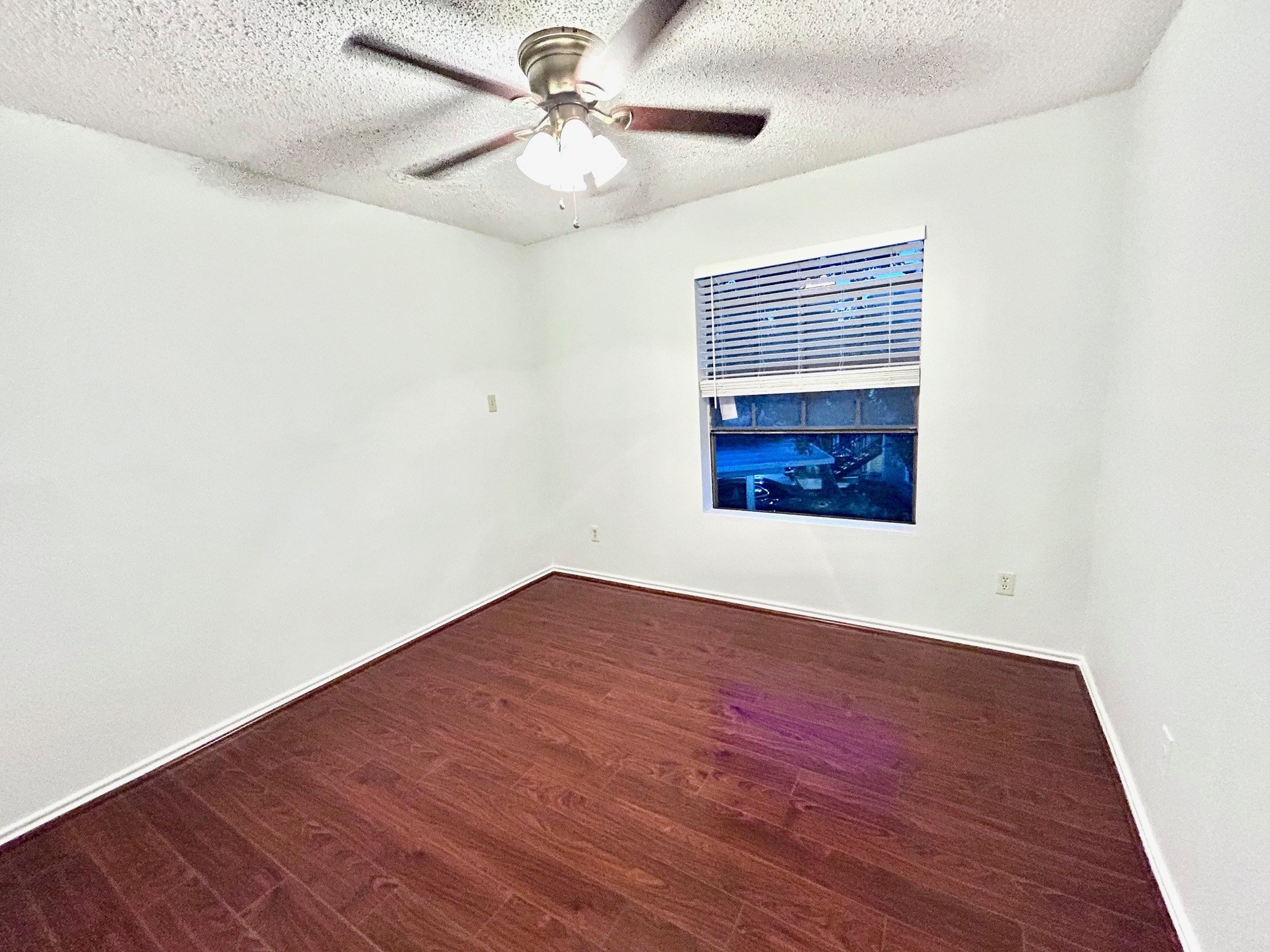 2750 Holly Hall Street, Unit 1014 Houston, TX 77054 - Photo 13 of 20 a view of an empty room with a window and wooden floor