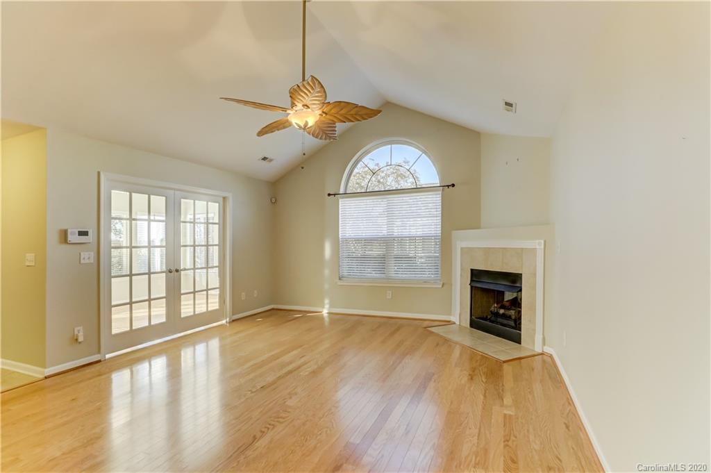 830 Ledgestone Court Tega Cay, SC 29708 - Photo 11 of 47 a view of an empty room with a window and wooden floor