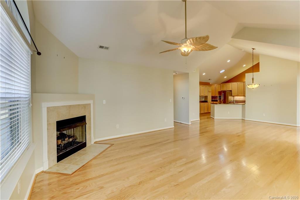 830 Ledgestone Court Tega Cay, SC 29708 - Photo 13 of 47 a view of a livingroom with a fireplace a ceiling fan and windows