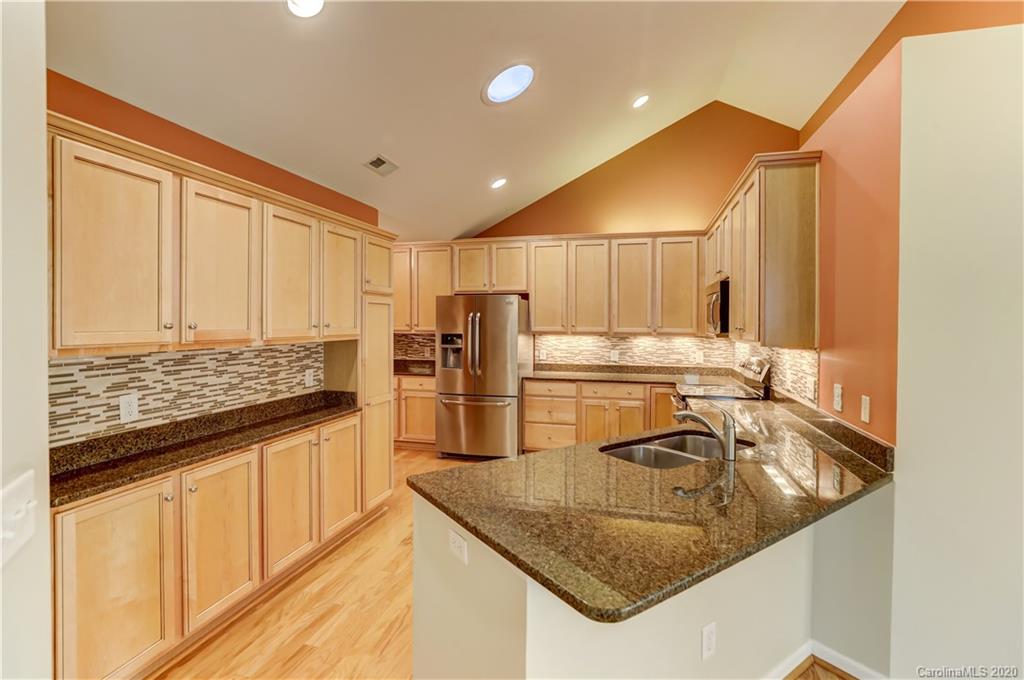 830 Ledgestone Court Tega Cay, SC 29708 - Photo 14 of 47 a kitchen with stainless steel appliances granite countertop a sink stove and refrigerator