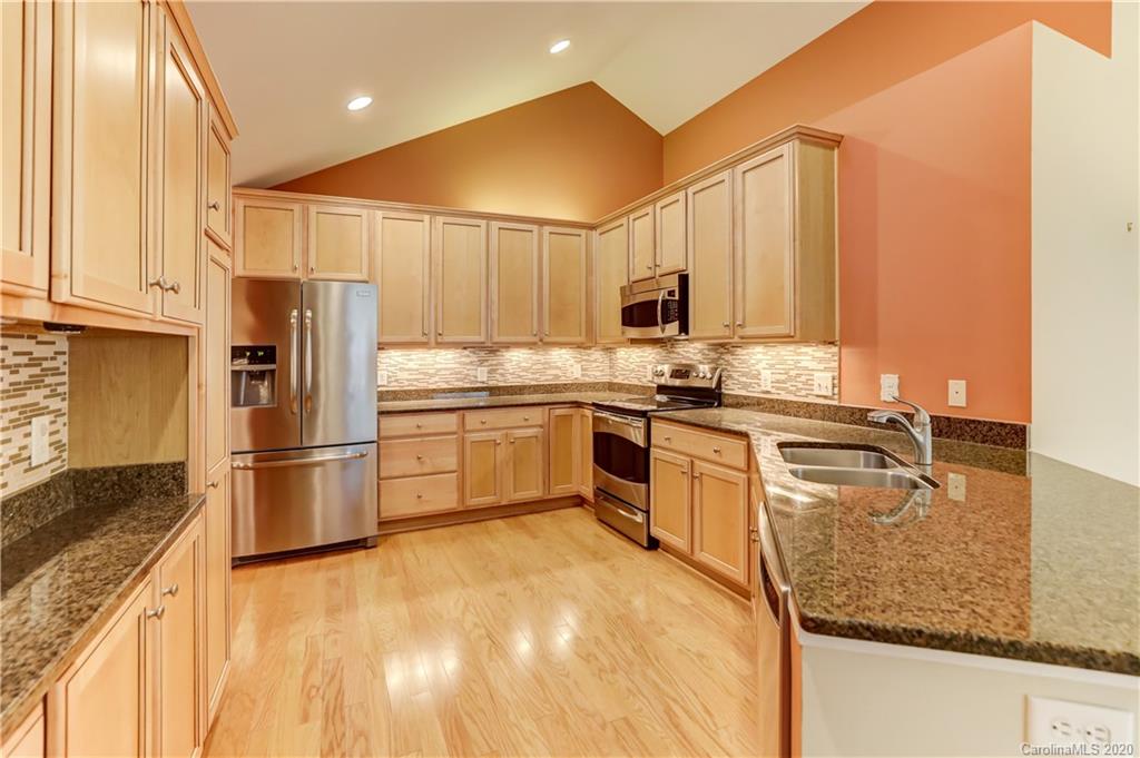 830 Ledgestone Court Tega Cay, SC 29708 - Photo 15 of 47 a kitchen with stainless steel appliances granite countertop a stove a sink and a refrigerator