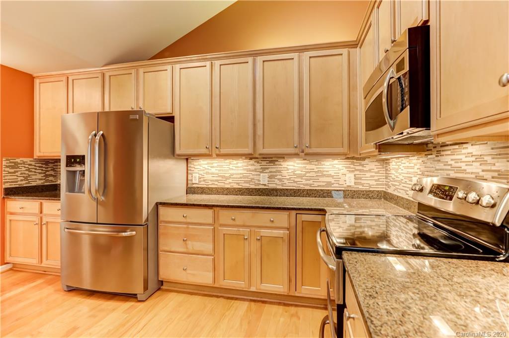 830 Ledgestone Court Tega Cay, SC 29708 - Photo 17 of 47 a kitchen with stainless steel appliances granite countertop a refrigerator sink and cabinets
