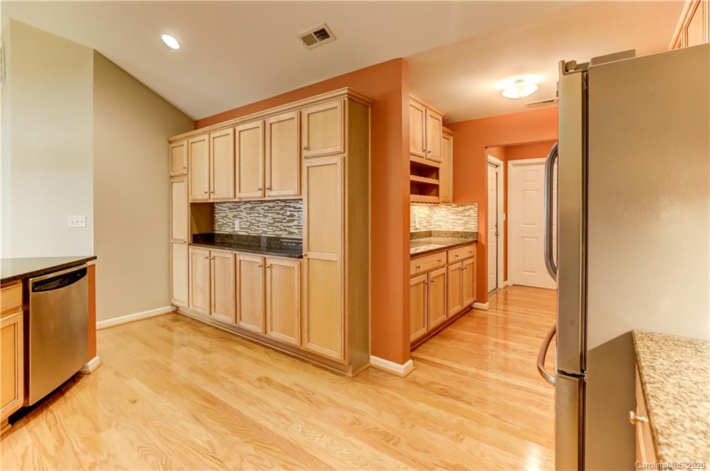 830 Ledgestone Court Tega Cay, SC 29708 - Photo 18 of 47 a view of hallway with cabinets and wooden floor