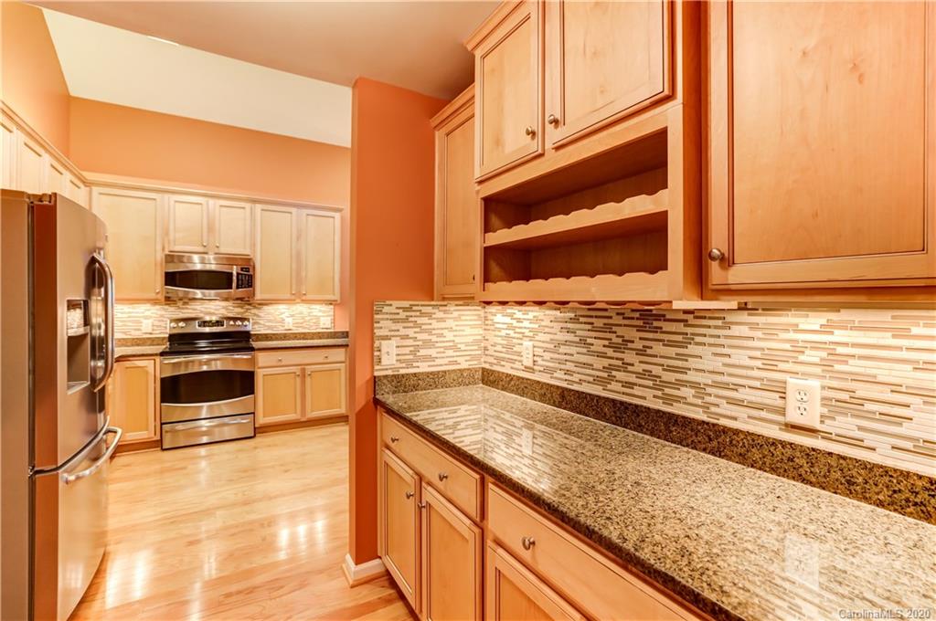 830 Ledgestone Court Tega Cay, SC 29708 - Photo 19 of 47 a kitchen with granite countertop a sink and stainless steel appliances