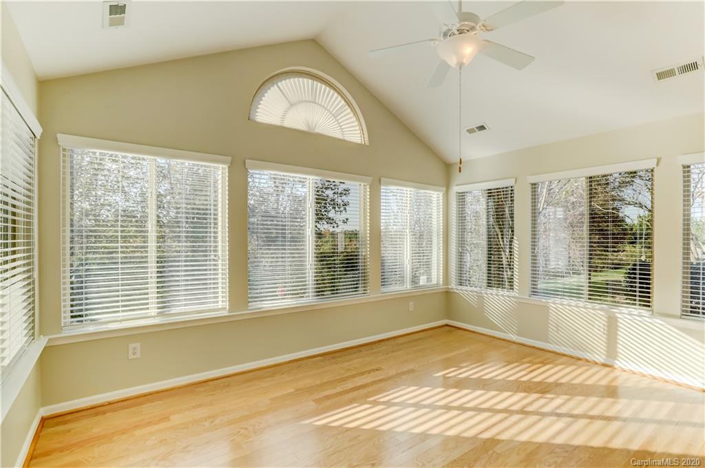 830 Ledgestone Court Tega Cay, SC 29708 - Photo 20 of 47 a view of an empty room with a window and a chandelier