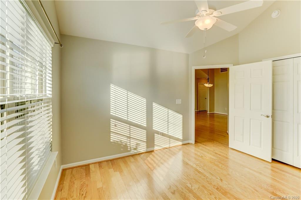 830 Ledgestone Court Tega Cay, SC 29708 - Photo 40 of 47 a view of an empty room with wooden floor and a window