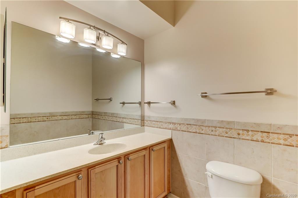 830 Ledgestone Court Tega Cay, SC 29708 - Photo 43 of 47 a bathroom with a sink a toilet a mirror and vanity