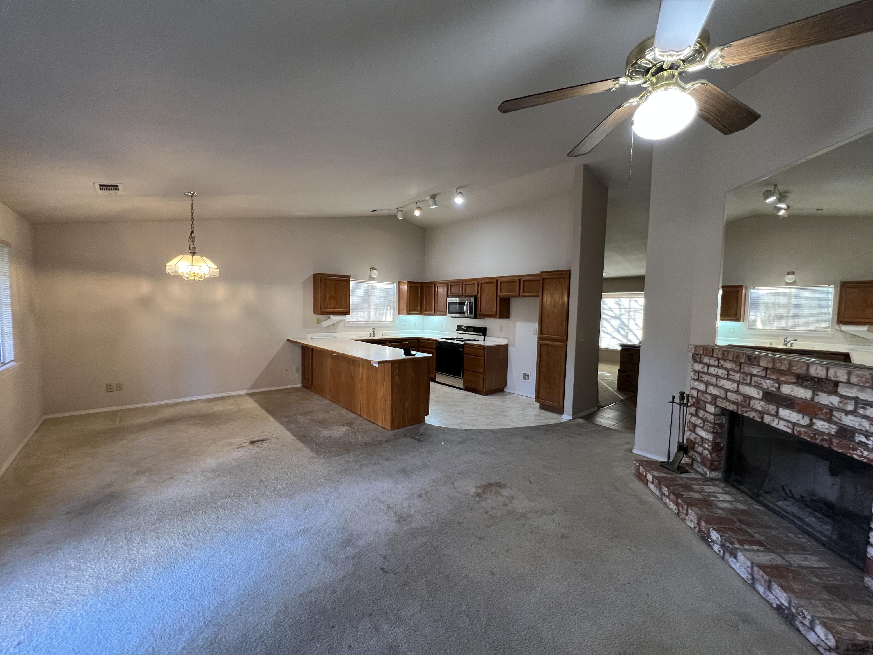 1459 Hominy Way Redding, CA 96003 - Photo 2 of 10 a large kitchen with a stove and a chandelier