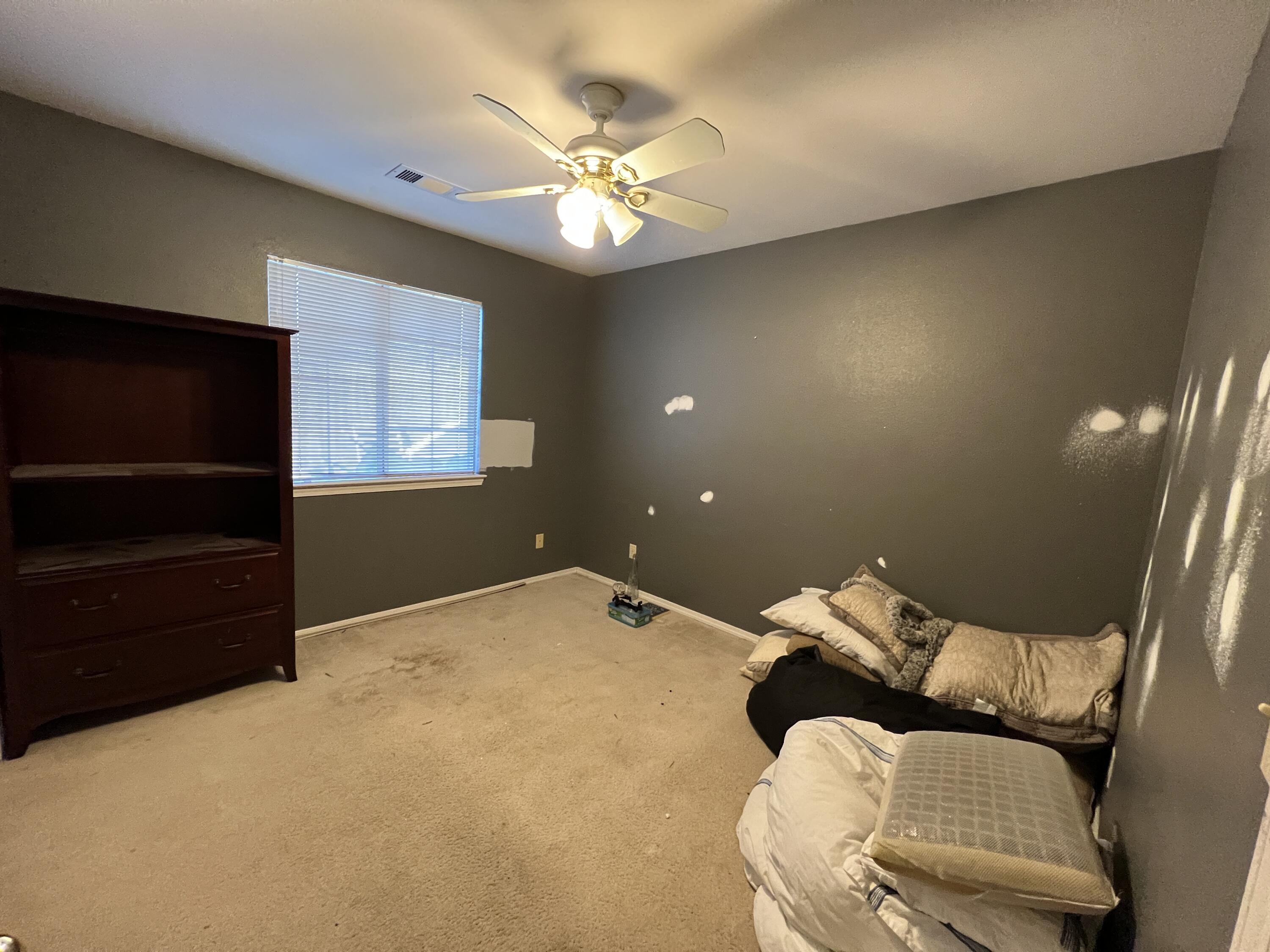 1459 Hominy Way Redding, CA 96003 - Photo 5 of 10 a bed room with a bed and a television