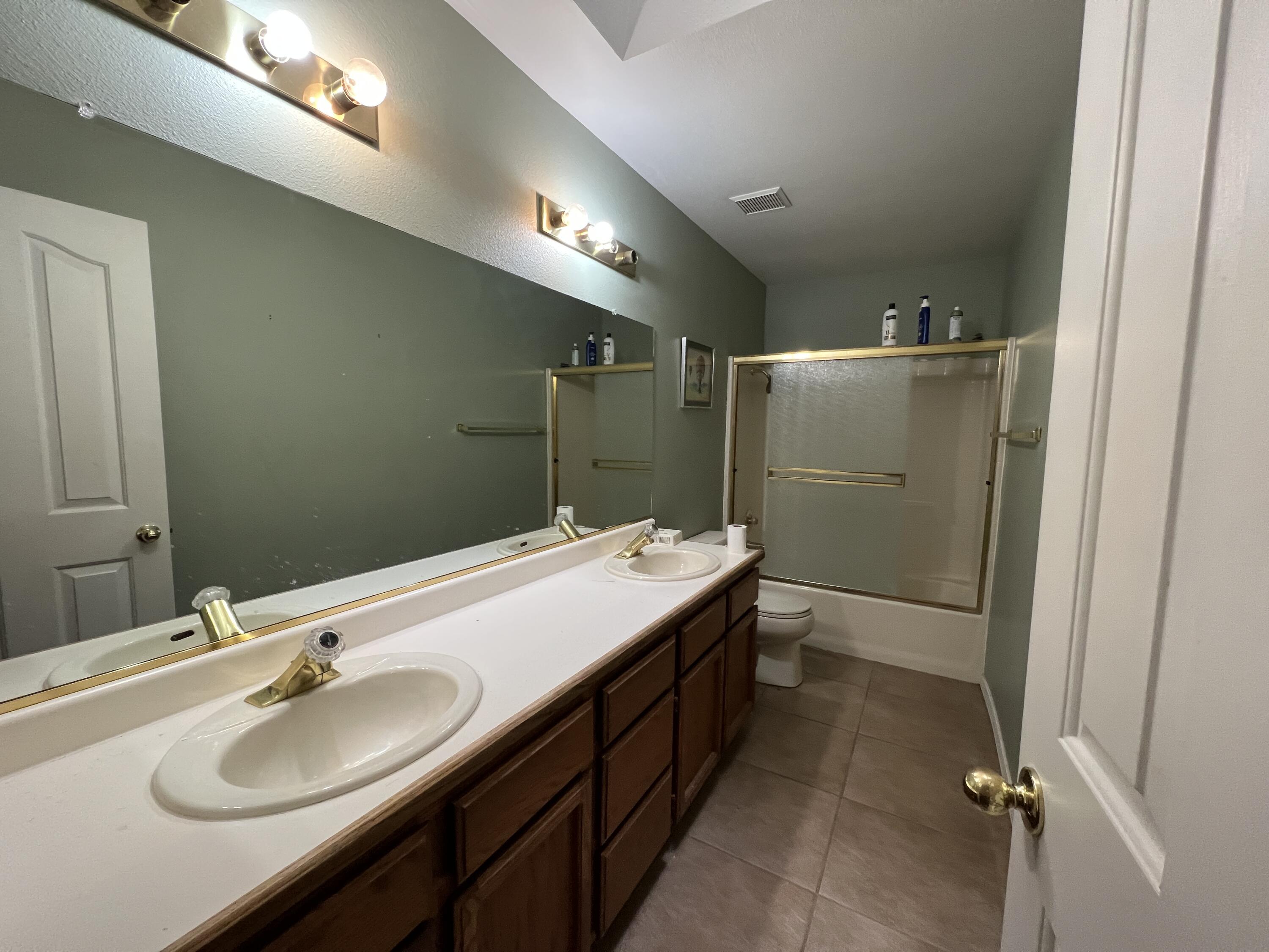 1459 Hominy Way Redding, CA 96003 - Photo 6 of 10 a bathroom with a double vanity sink and mirror