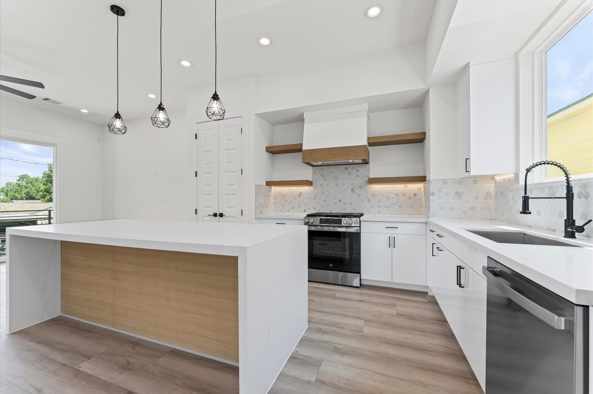 4104 Alice Street Houston, TX 77021 - Photo 14 of 28 a kitchen with stainless steel appliances a sink stove and cabinets