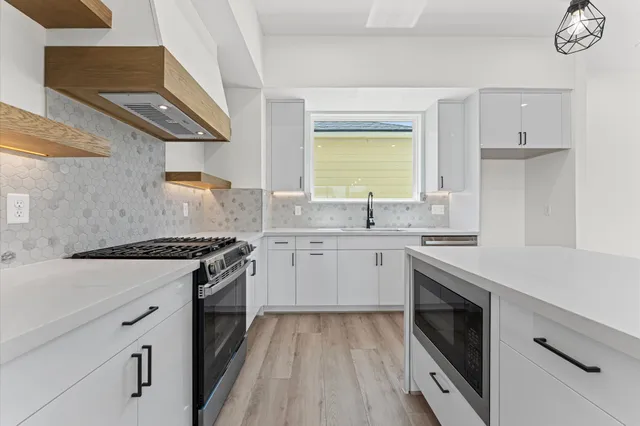 a bathroom with a double vanity sink toilet mirror and bathtub