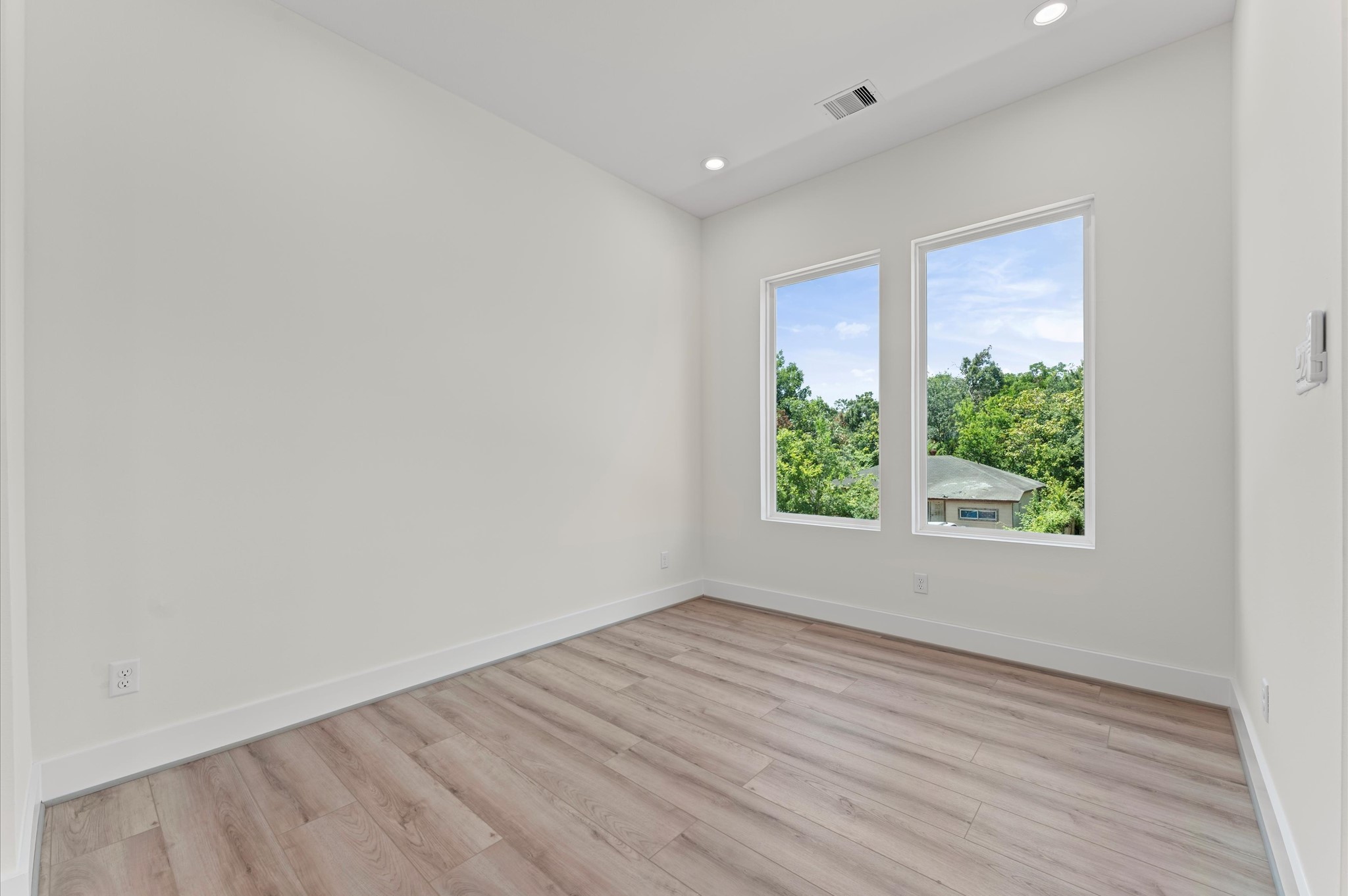 4104 Alice Street Houston, TX 77021 - Photo 22 of 28 an empty room with wooden floor and windows