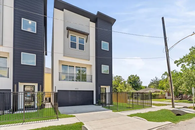 a front view of a house with a garden and plants