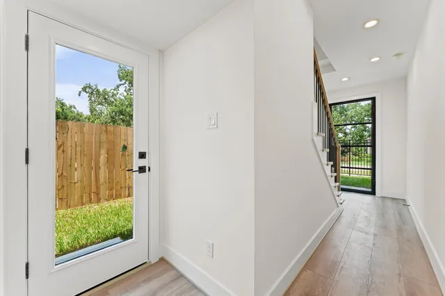 a large kitchen with stainless steel appliances kitchen island a large counter top and a wooden floors