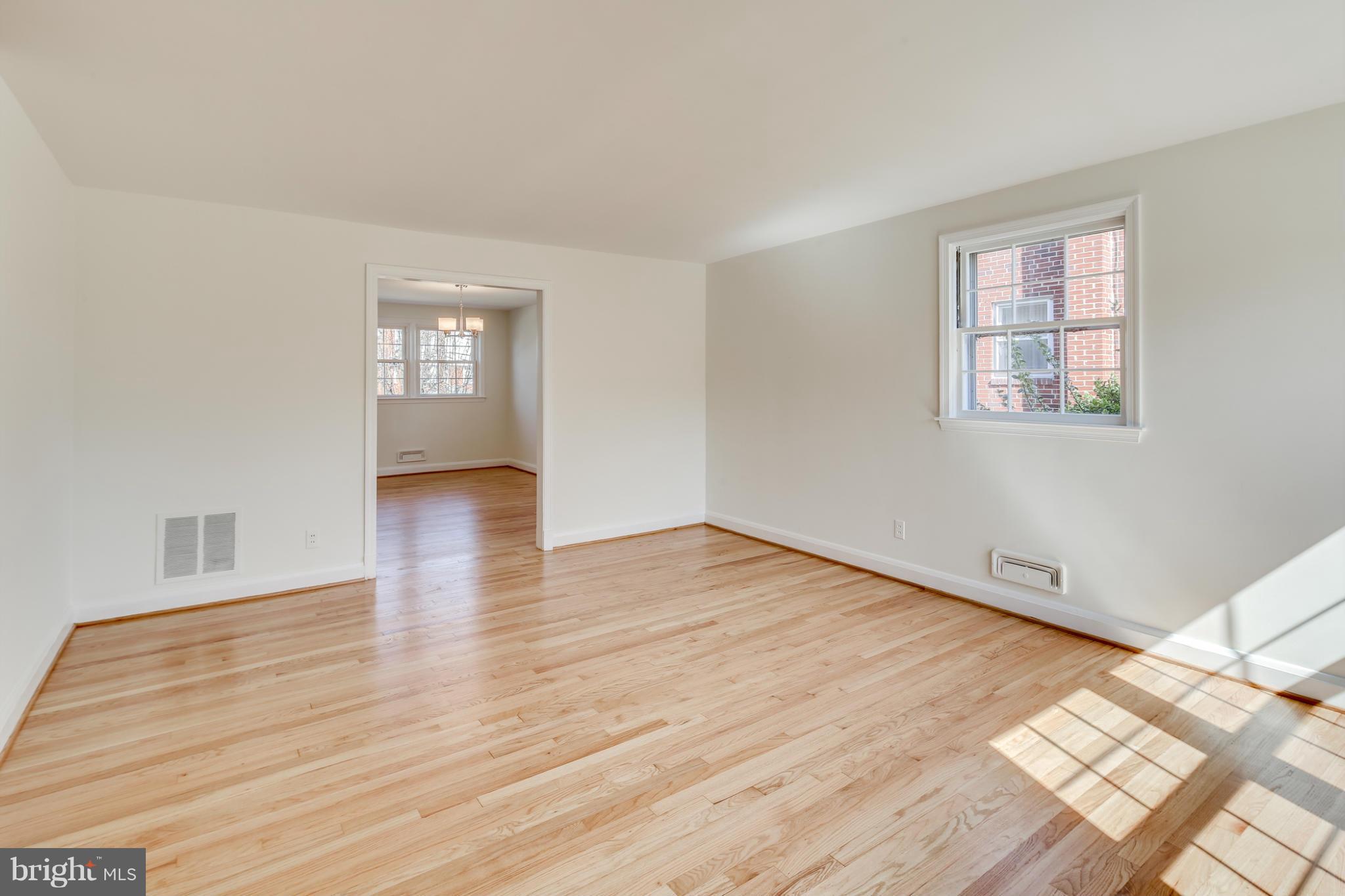 1512 Langford Road Baltimore, MD 21207 - Photo 2 of 30 a view of an empty room with wooden floor and a window