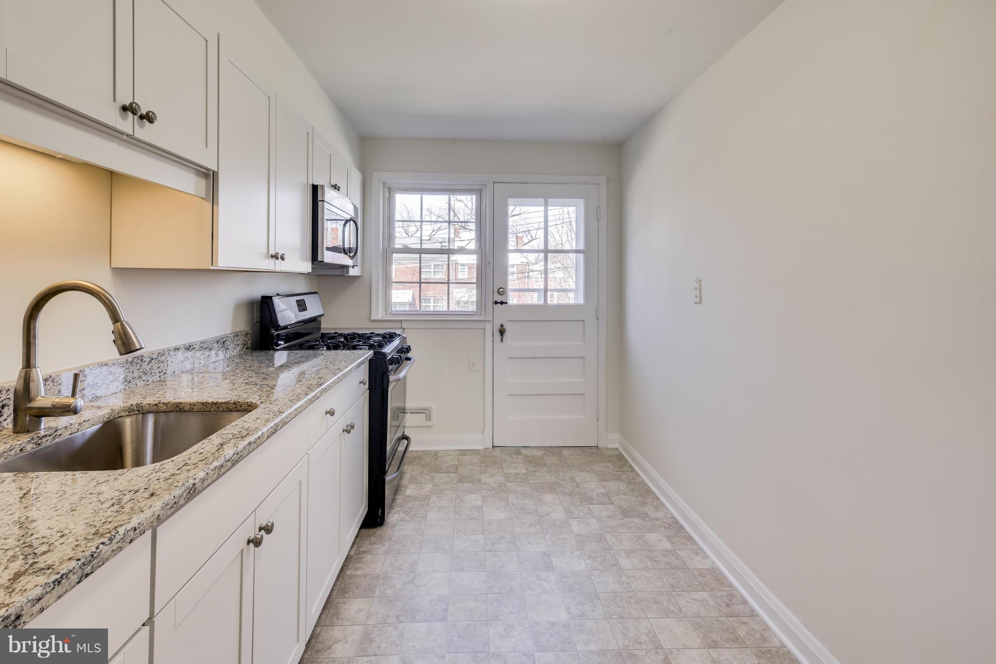 1512 Langford Road Baltimore, MD 21207 - Photo 11 of 30 a kitchen with a sink and cabinets