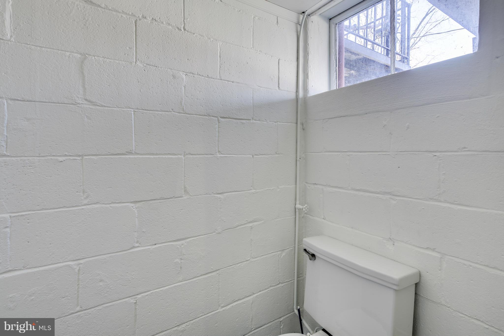 1512 Langford Road Baltimore, MD 21207 - Photo 12 of 30 a bathroom with a white toilet and a window