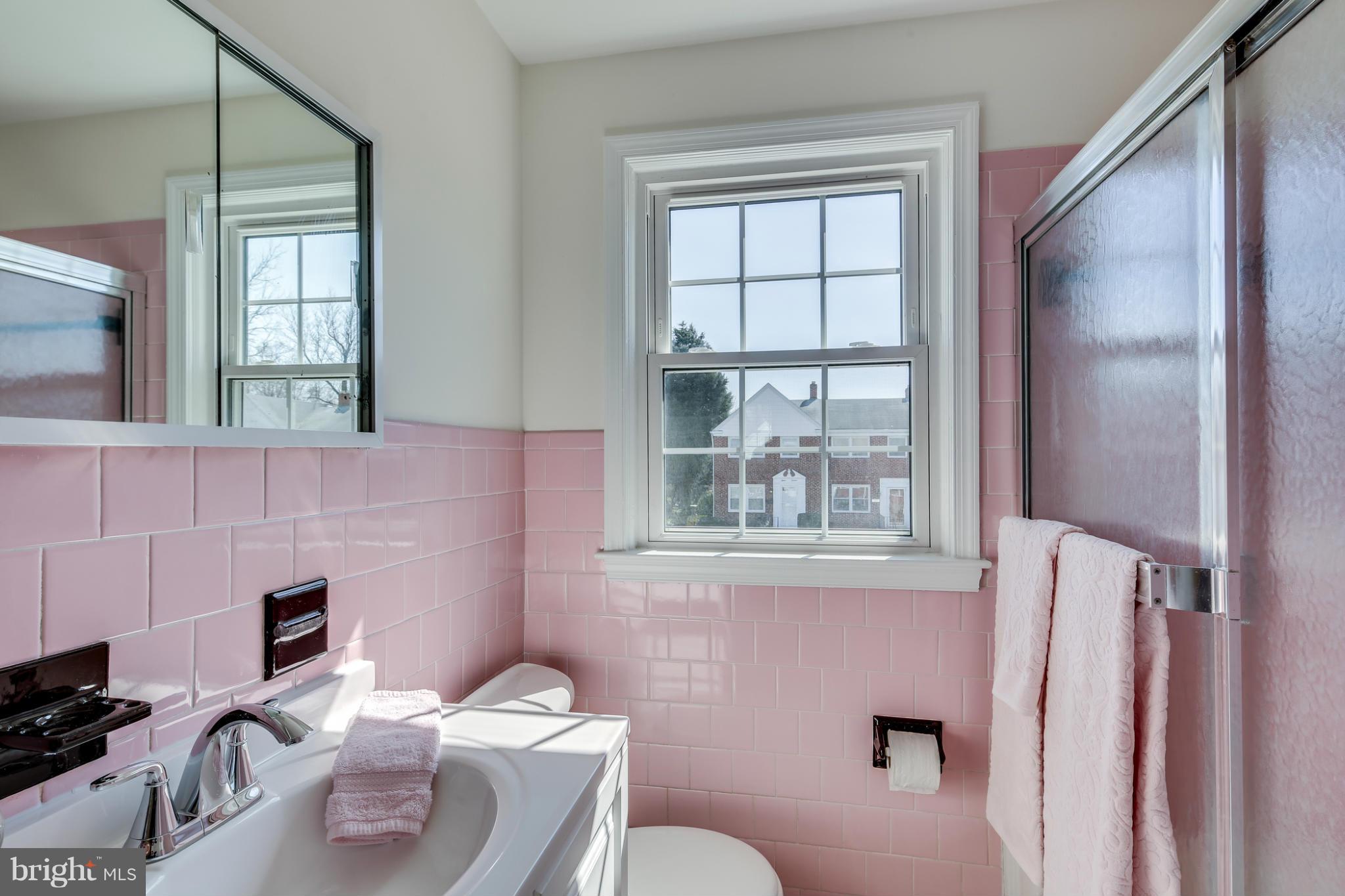 1512 Langford Road Baltimore, MD 21207 - Photo 16 of 30 a bathroom with a sink a toilet and a mirror