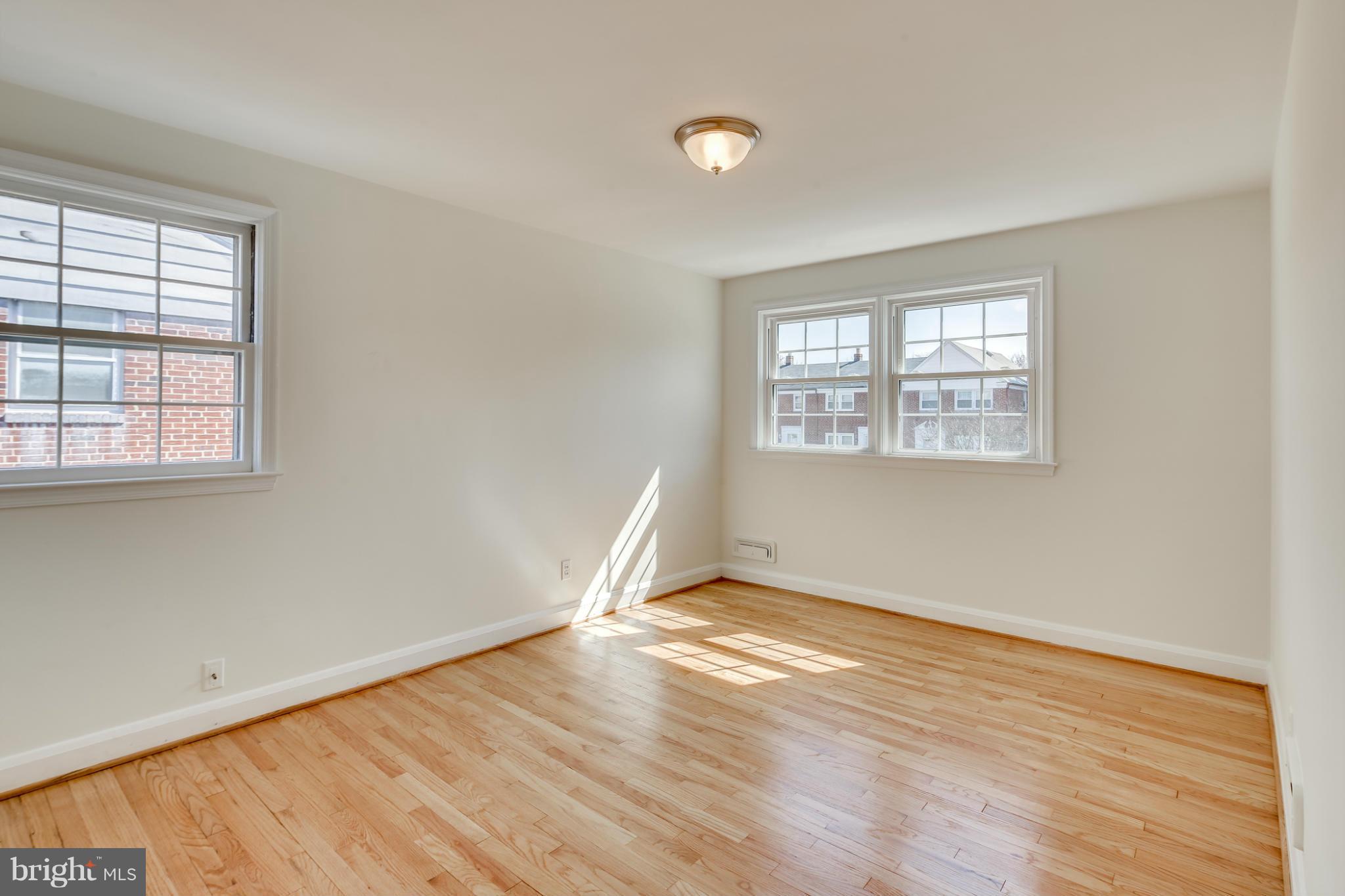 1512 Langford Road Baltimore, MD 21207 - Photo 18 of 30 an empty room with wooden floor and windows