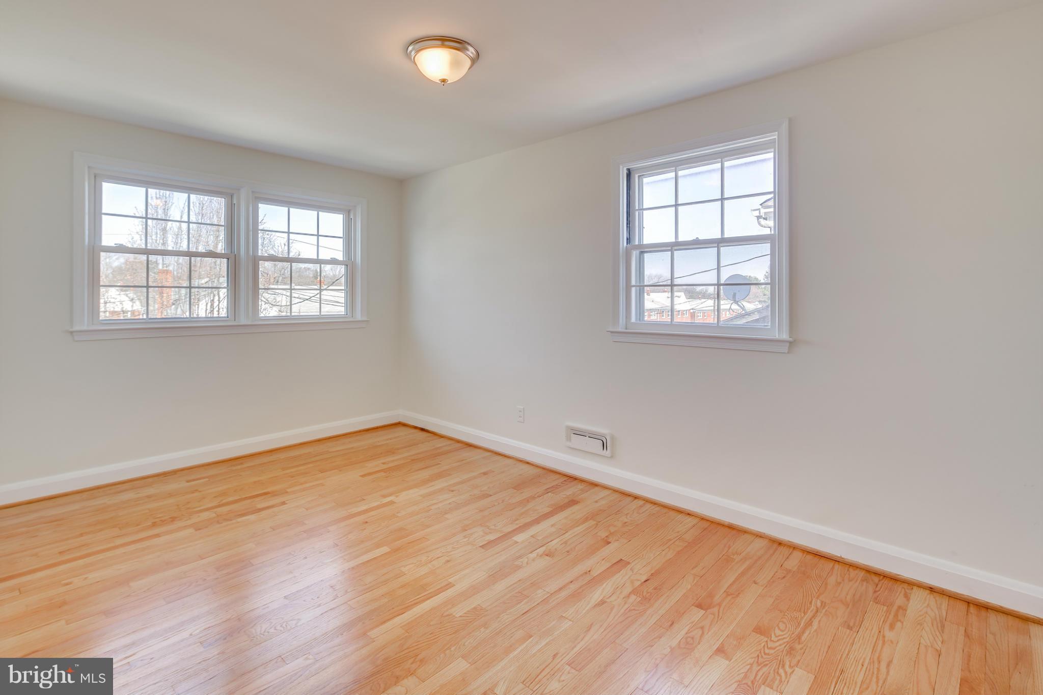 1512 Langford Road Baltimore, MD 21207 - Photo 21 of 30 an empty room with wooden floor and windows