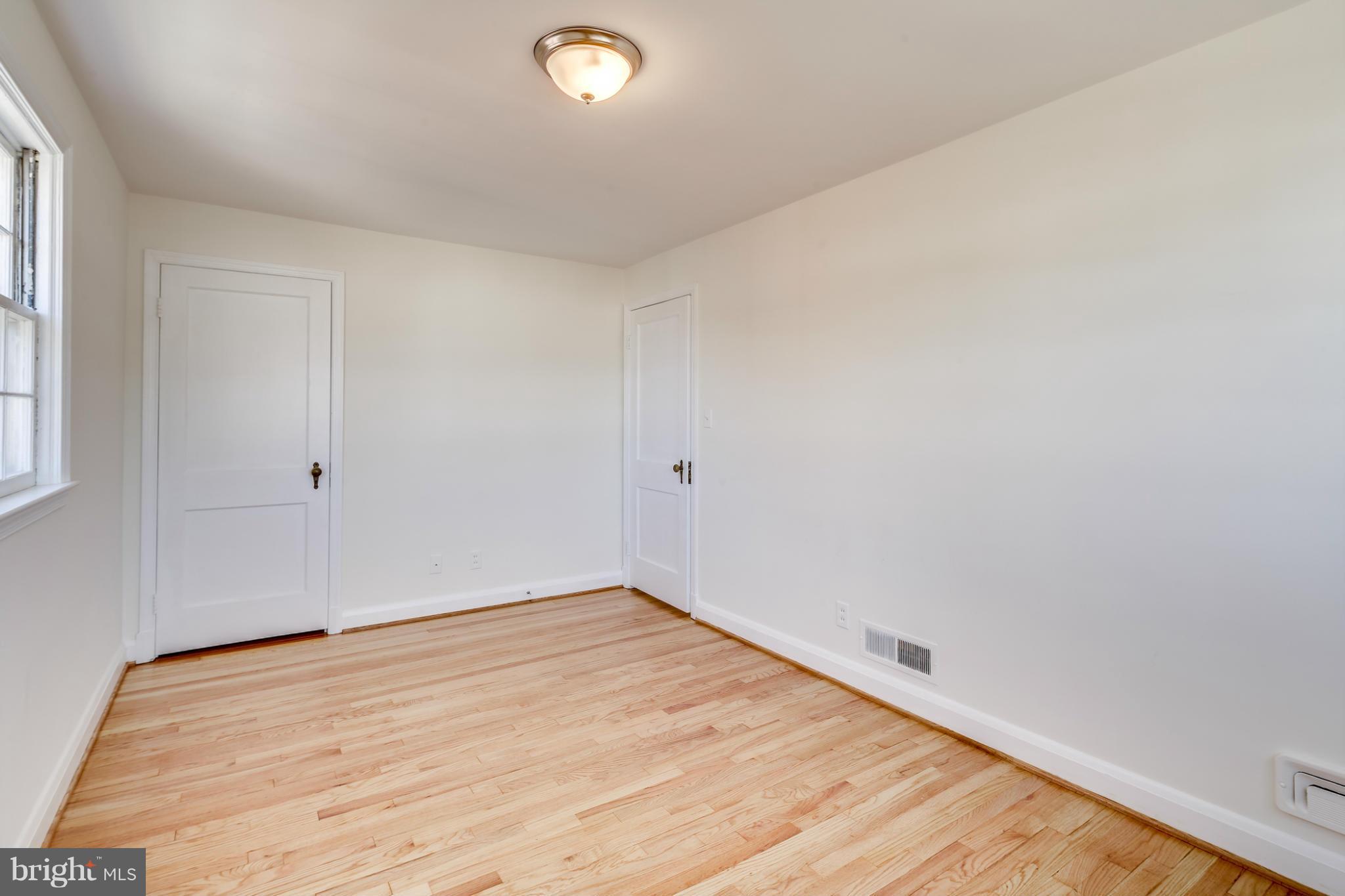 1512 Langford Road Baltimore, MD 21207 - Photo 23 of 30 an empty room with wooden floor