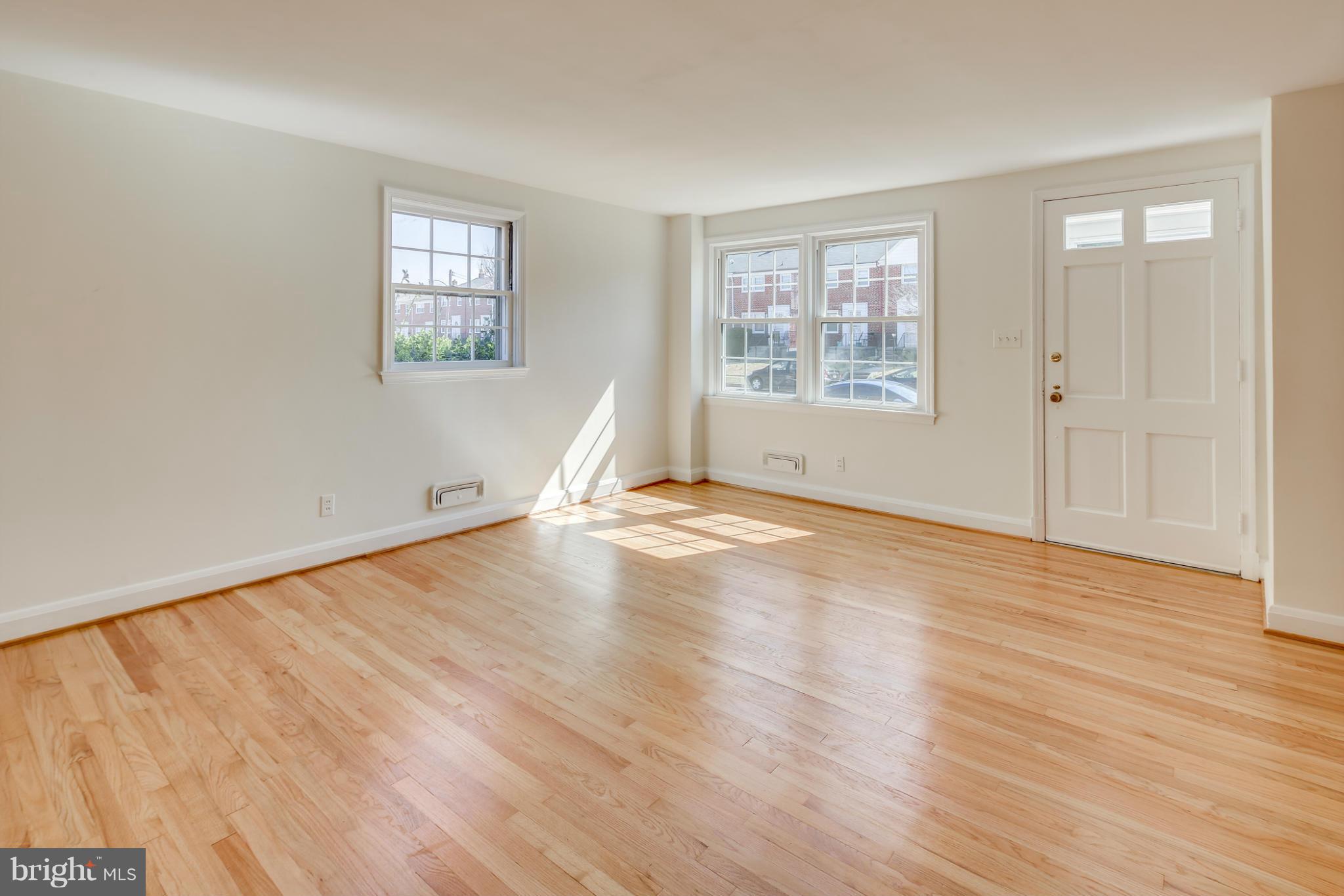 1512 Langford Road Baltimore, MD 21207 - Photo 5 of 30 an empty room with wooden floor and windows