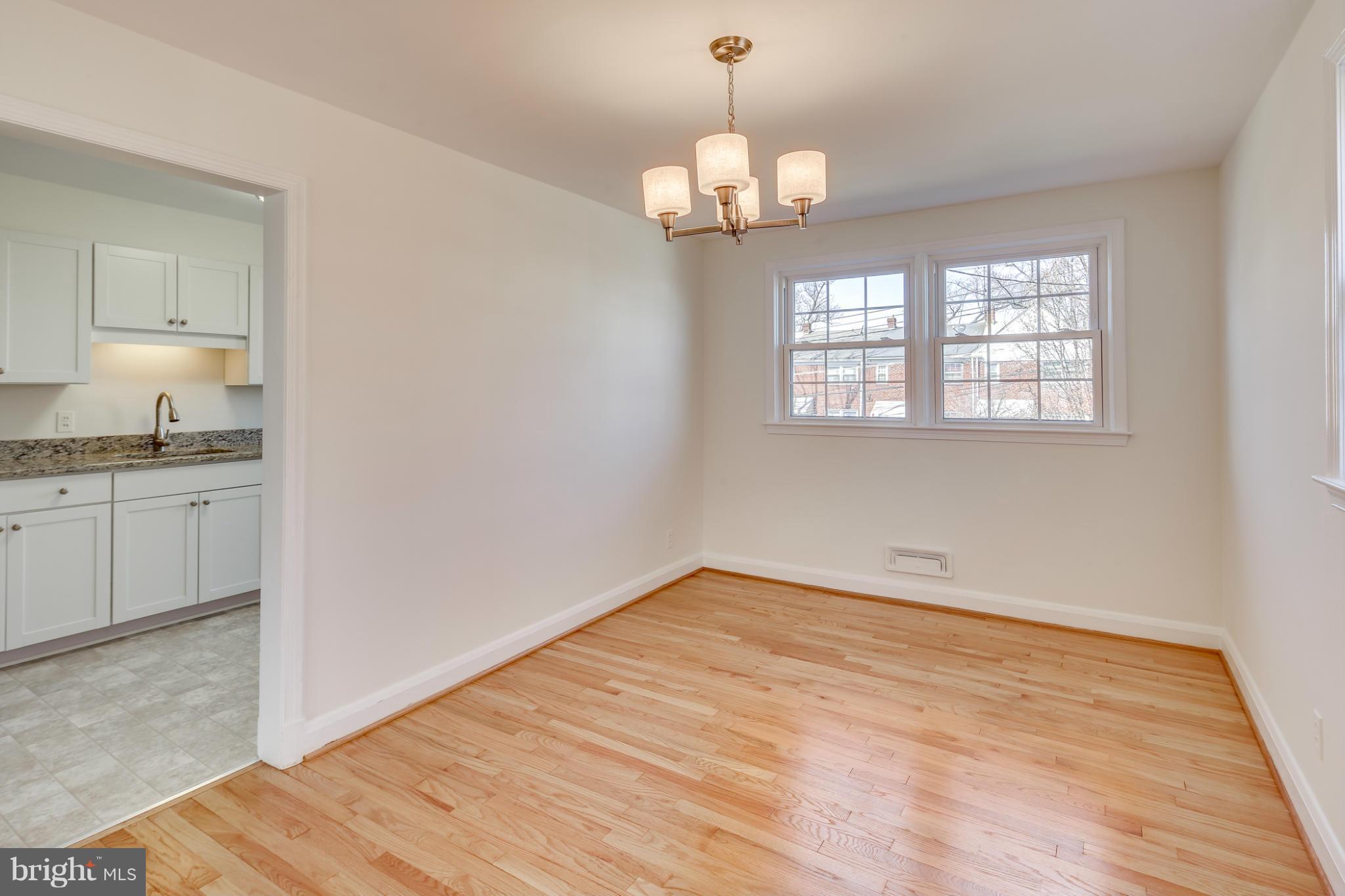 1512 Langford Road Baltimore, MD 21207 - Photo 7 of 30 a view of an empty room with wooden floor and a window
