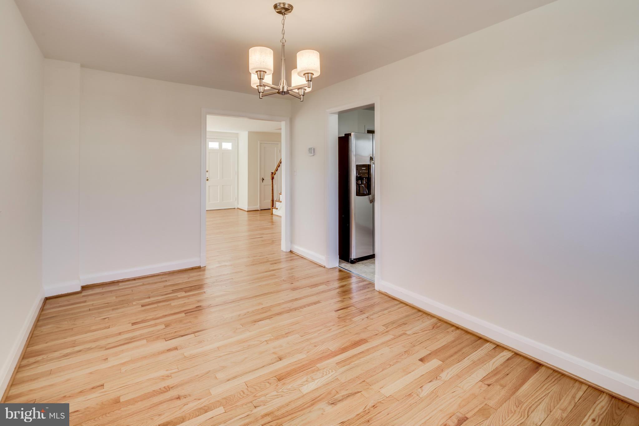 1512 Langford Road Baltimore, MD 21207 - Photo 8 of 30 a view of livingroom with hardwood floor and kitchen view